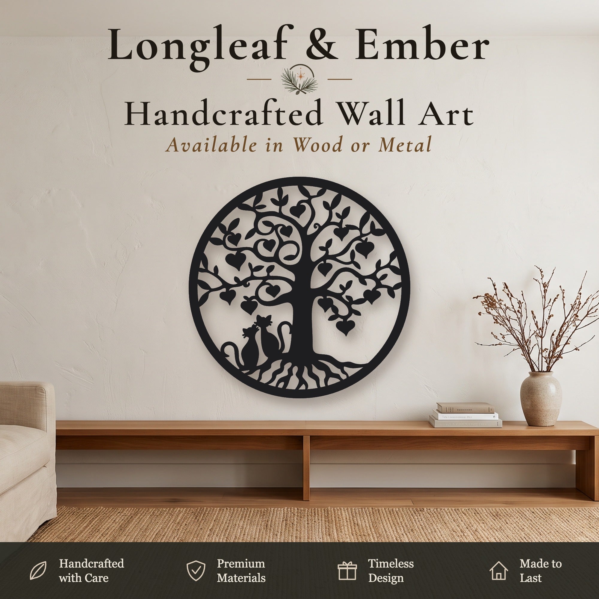 Black metal longleaf and ember tree wall art with a cat silhouette, displayed on a beige wall above a wooden console table in a styled room setting.