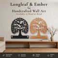 Two personalized Tree of Life wall art pieces with butterfly heart design and name plate, one in black metal and one in stained wood