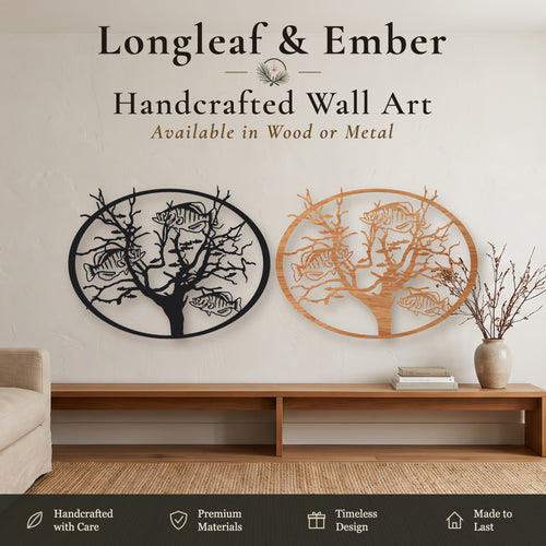 Two oval Tree of Life wall art pieces with fish design, one in black metal and one in stained wood, displayed above a wooden console table.