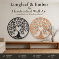 Two round Tree of Life wall art pieces with heart cutout in the trunk and birds in the branches, one in black metal and one in stained wood.