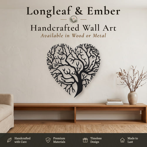 Black heart-shaped metal wall art featuring a detailed tree design, displayed on a beige wall in a modern living room setting above a wooden console table.