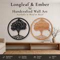 Two round Tree of Life wall art pieces, one in black metal and one in stained wood, displayed above a wooden console table.

