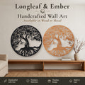 Two round windswept Tree of Life wall art pieces, one in black metal and one in stained wood, displayed above a wooden console table